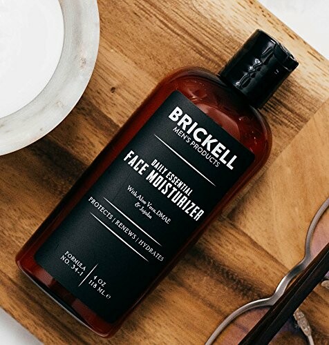 Brickell Men's Products Face Moisturizer bottle on a wooden surface