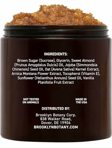 Jar of body scrub with ingredient list and distribution details on label.