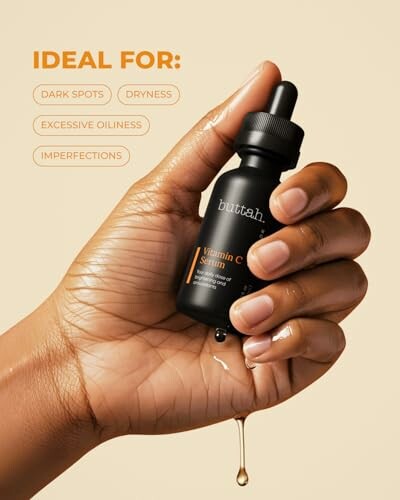 Hand holding Buttah Vitamin C Serum bottle.