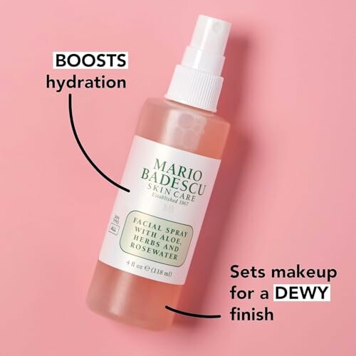 Facial spray with aloe, herbs, and rosewater on pink background.