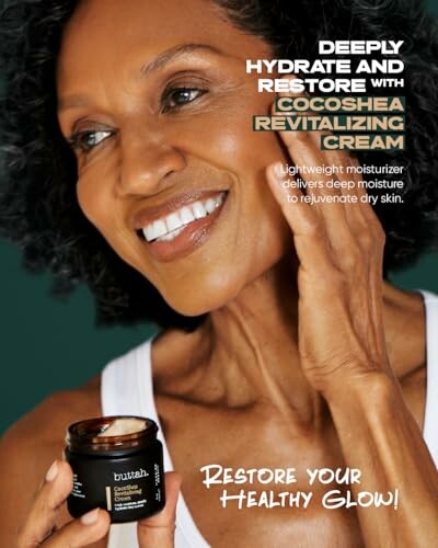Smiling woman applying Cocoshea Revitalizing Cream to her face.